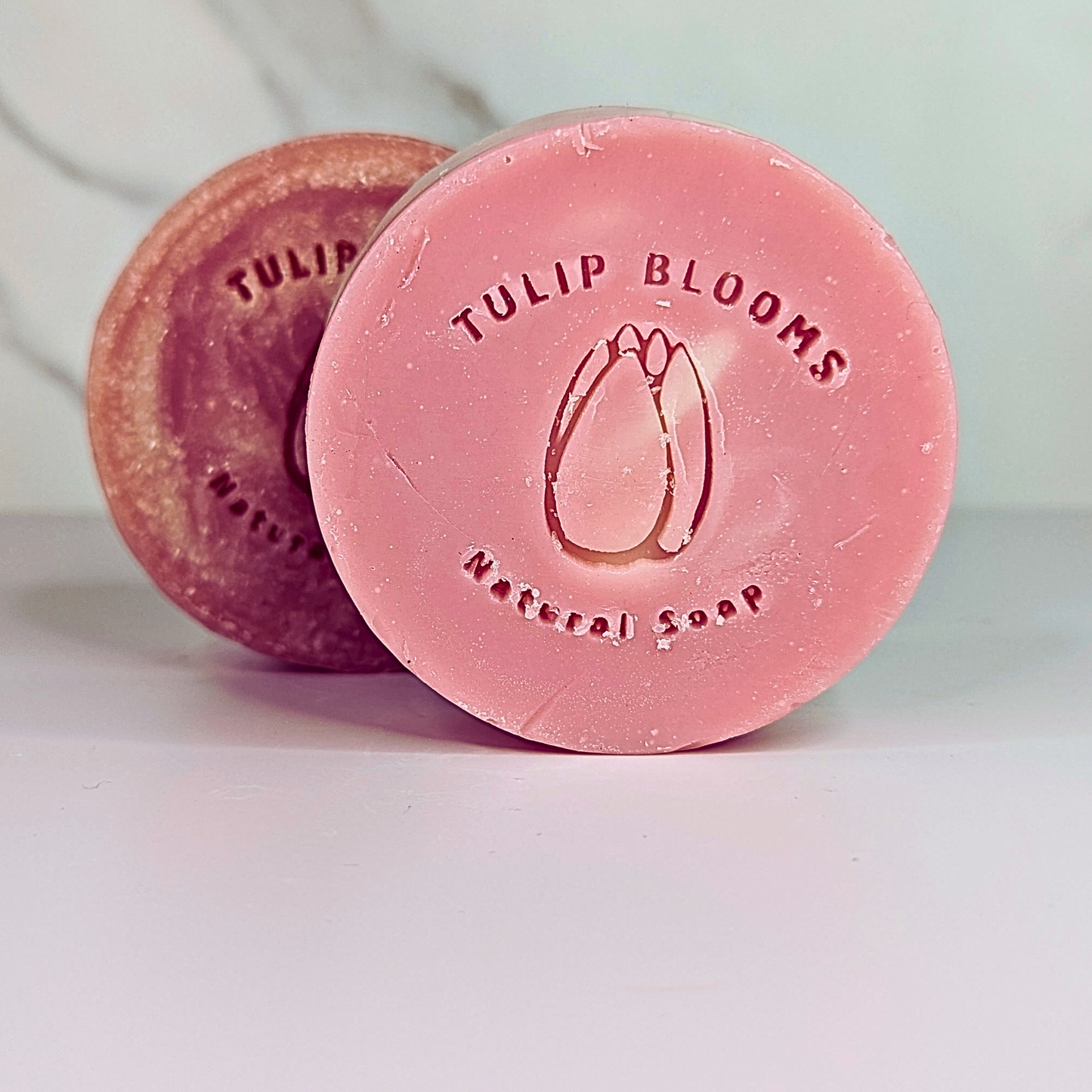 Round pink Tulip Blooms soap discs with stamped logo