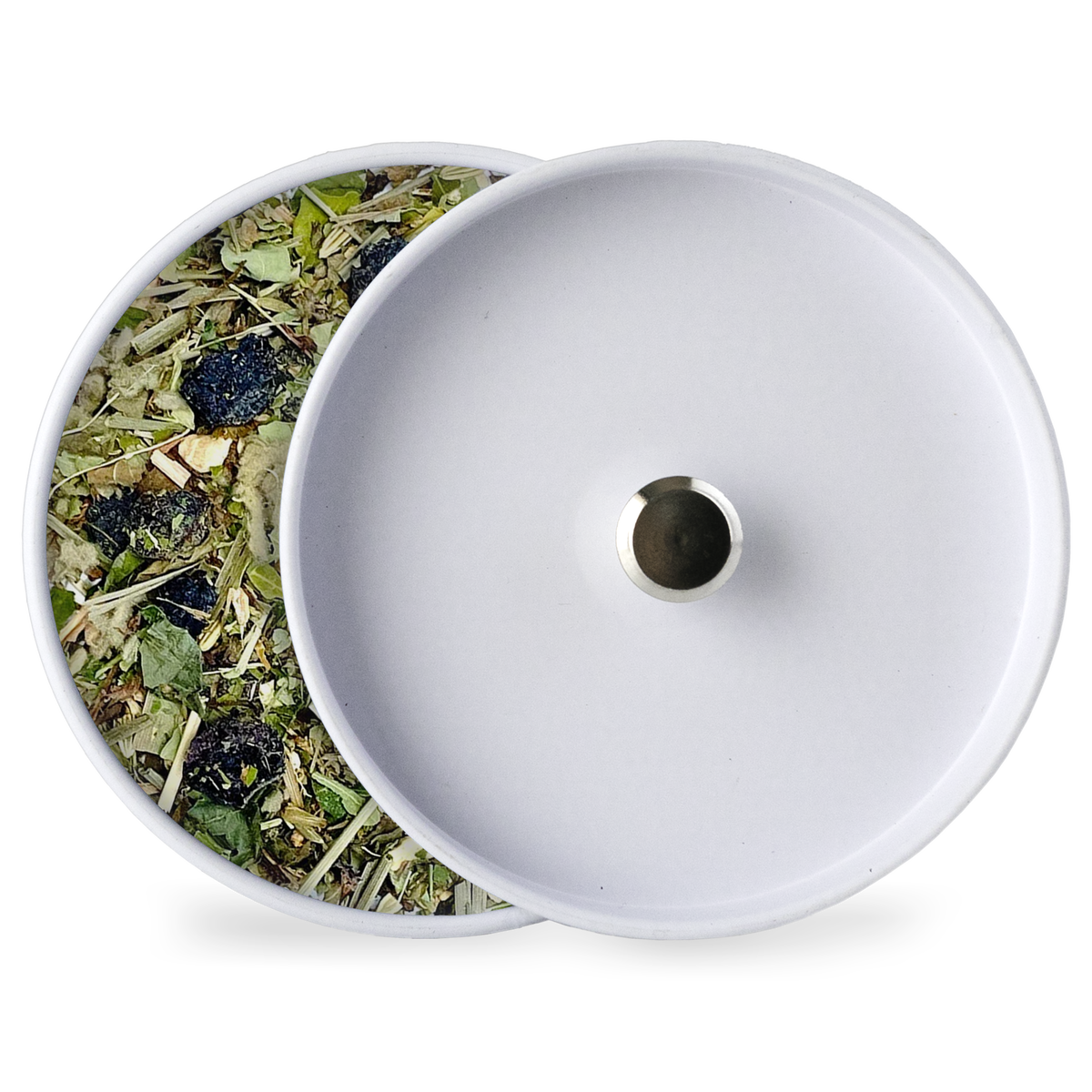 White tin lid with herbal tea blend beside it