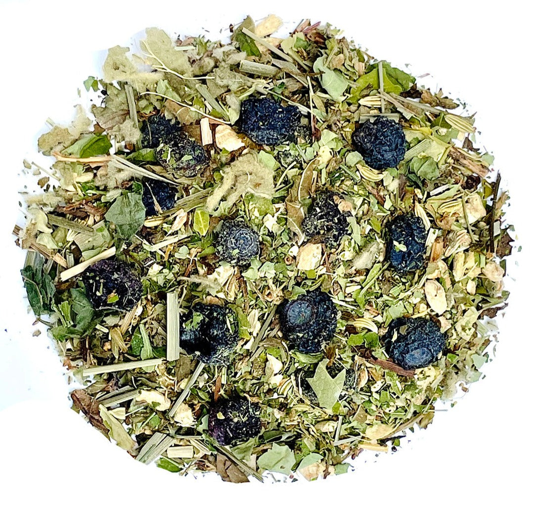 Herbal tea blend leaves and dried berries scattered