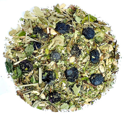 Herbal tea blend leaves and dried berries scattered