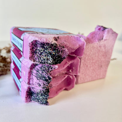 Pink sea salt soap bars with glitter-speckled edges, stacked at an angle