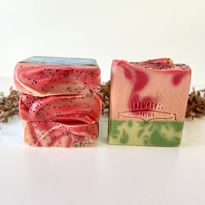 Watermelon goat milk soap bars: pink, speckled, and a green-and-pink bar