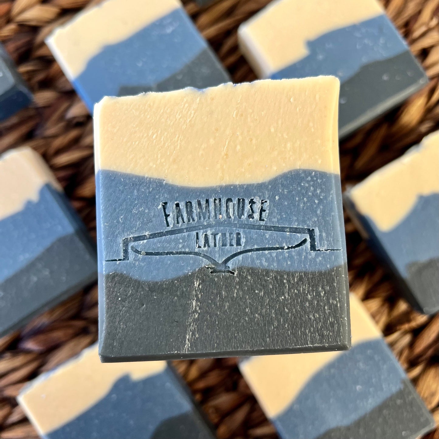 Marbled soap bar, pale cream and dark blue with stamped label on front