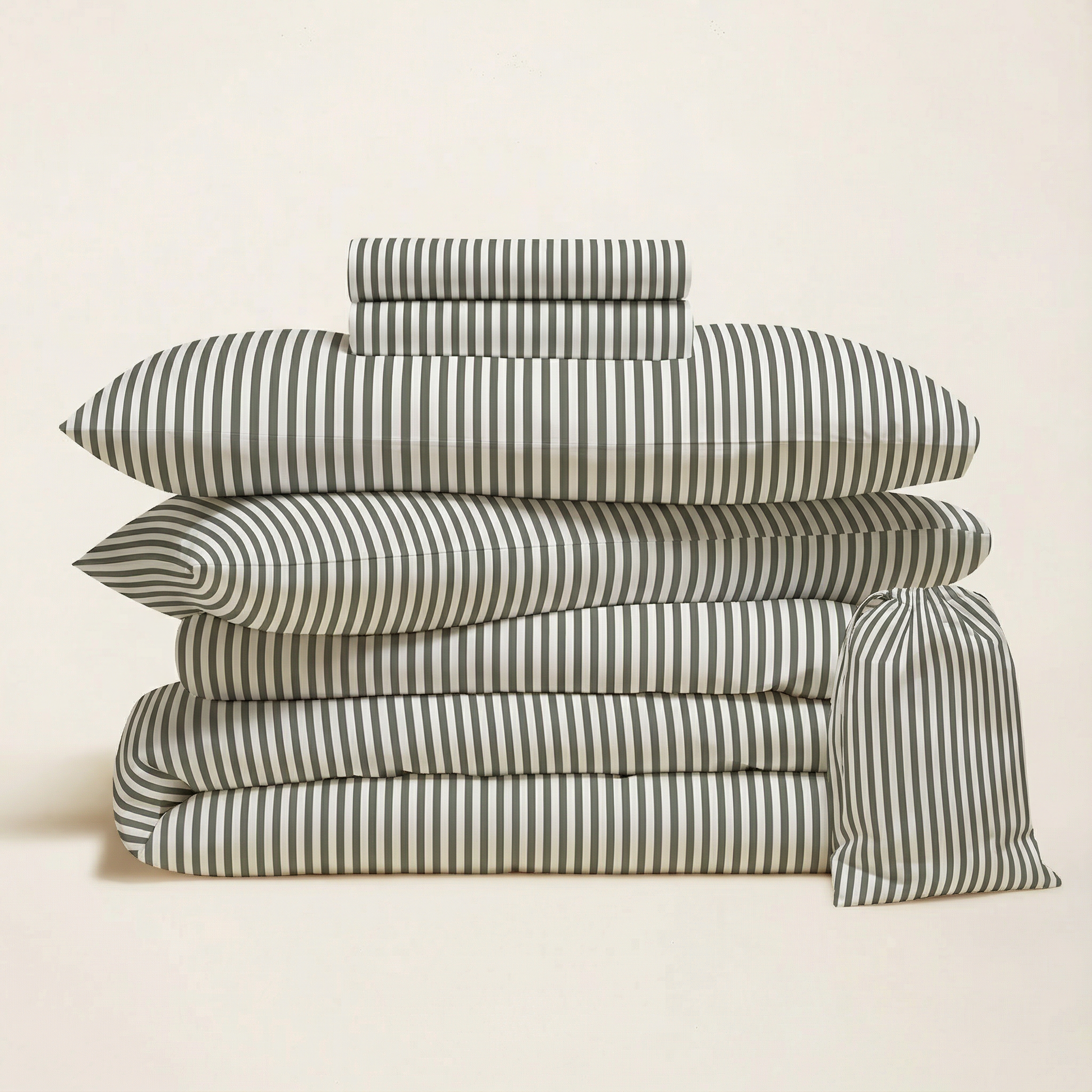 Striped bedding bundle with folded duvet, pillow shams, and extra matching pillowcase