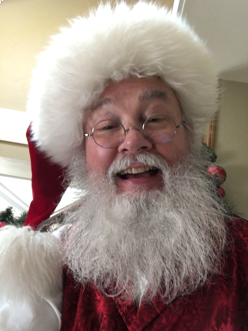 Organic beard oil; man with white beard wearing fluffy white hat, close-up