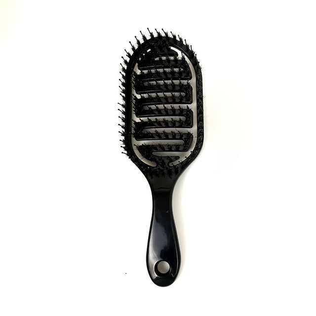 Glossy black massage hair comb with pin tips and oval thumb hole on handle