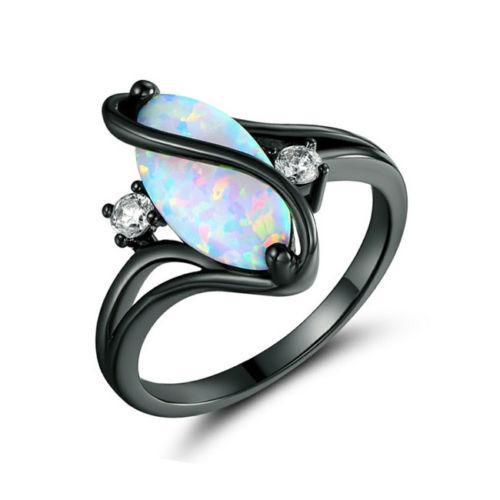 Black metal opal ring with marquise opal and two small clear side stones