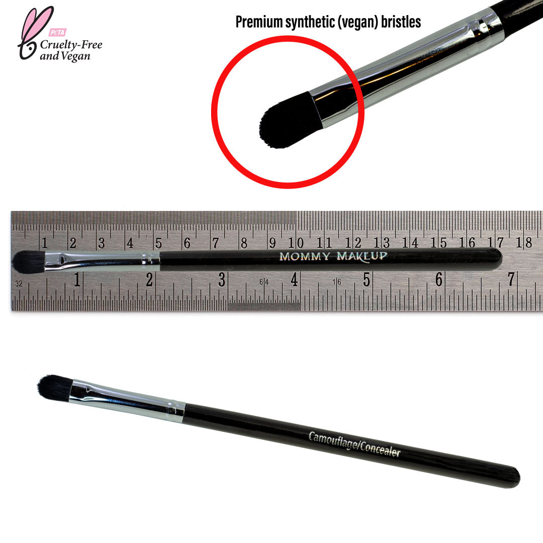 Concealer brush with black handle and dense black bristles, shown with ruler for size