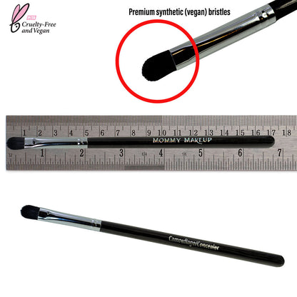 Concealer brush with black handle and dense black bristles, shown with ruler for size