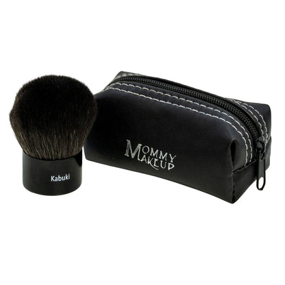 Kabuki makeup brush with black bristles beside zip pouch, Mommy Makeup logo