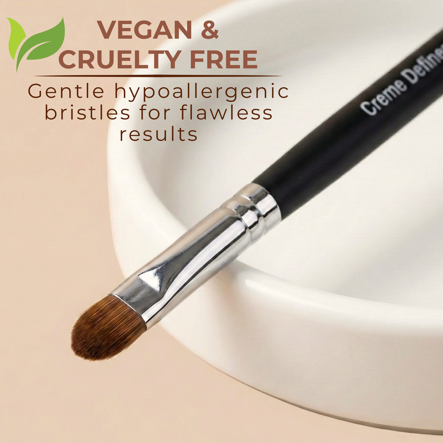 Creme Definer brush with silver ferrule and brown bristle tip on black handle