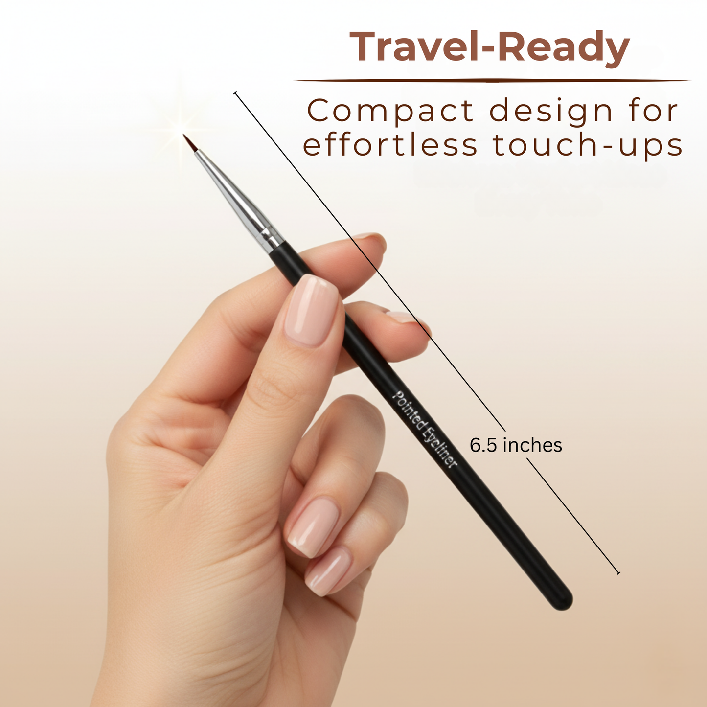 Pointed eyeliner brush held in hand; black handle, silver ferrule, tapered tip