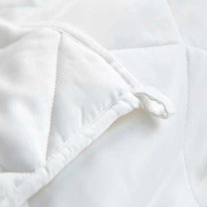 White duvet comforter corner close-up with stitched edge and inner baffling