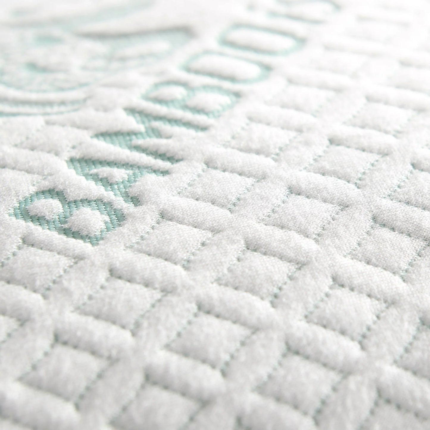 Adjustable cooling pillow close-up of white textured cover with mint accent pattern