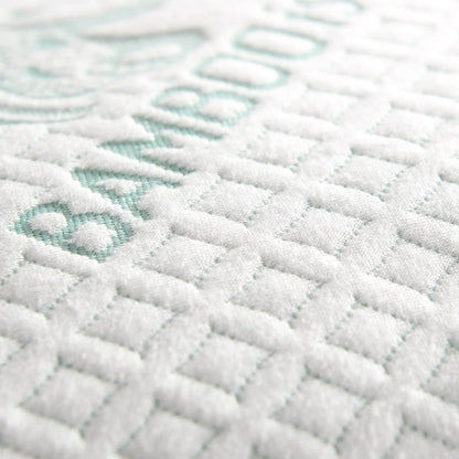 Adjustable cooling pillow close-up of white textured cover with mint accent pattern