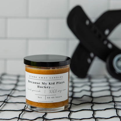Natural soy wax candle in glass jar with orange wax and black lid