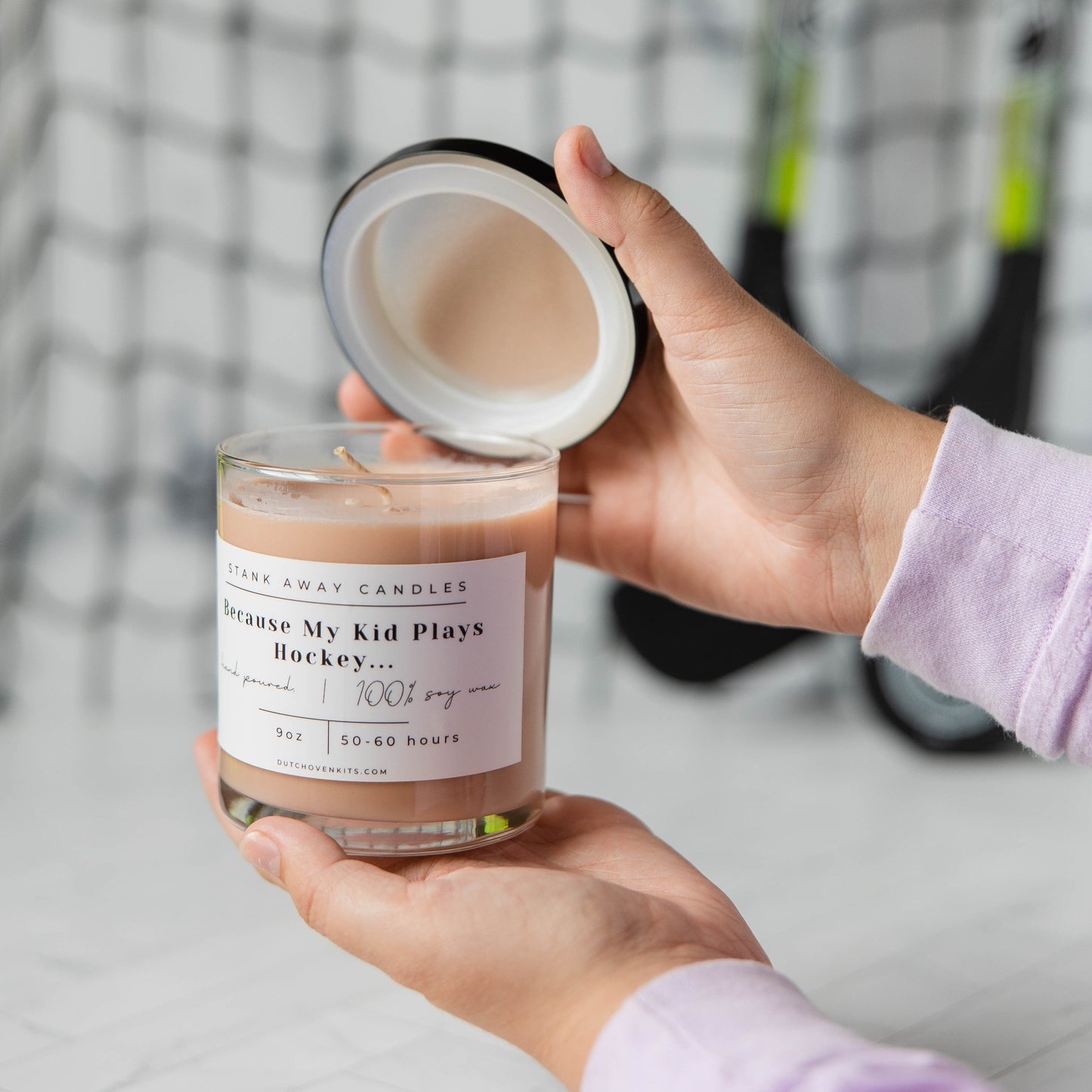 Natural soy wax candle in clear glass jar with light beige wax, open lid