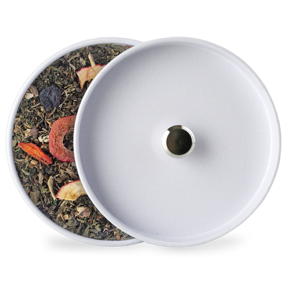 Loose berry tea blend in a white lidded container, visible dried fruit pieces