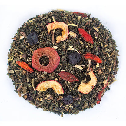 Loose green tea blend with red and yellow dried fruit slices and dark berries