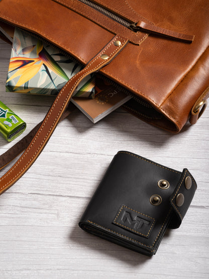 Black leather wallet with metal snap buttons and stitched logo patch