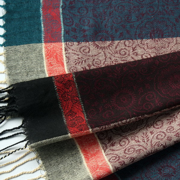 Pashmina scarf close-up of woven pattern, plaid panel and dangling fringe threads