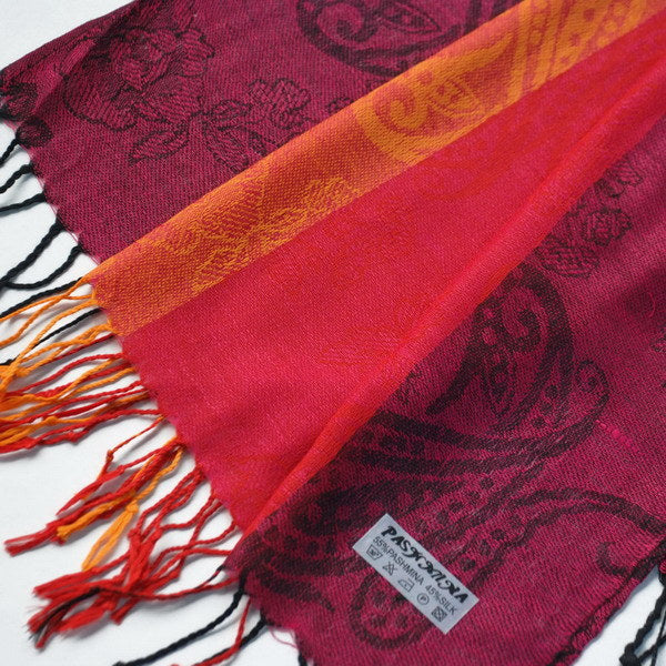 Paisley pashmina scarf close-up with burgundy fabric, orange border, and fringes