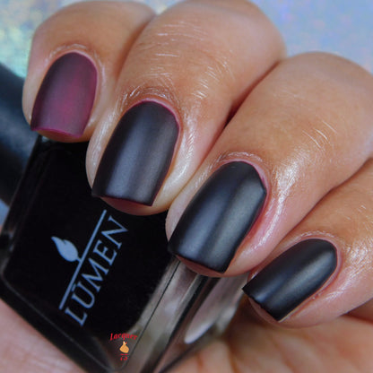 Dark matte fingernails with nail polish bottle showing LUMEN logo