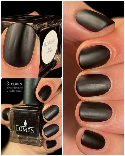 Nail polish bottle and matte dark nail polish on fingers, oval nails shown
