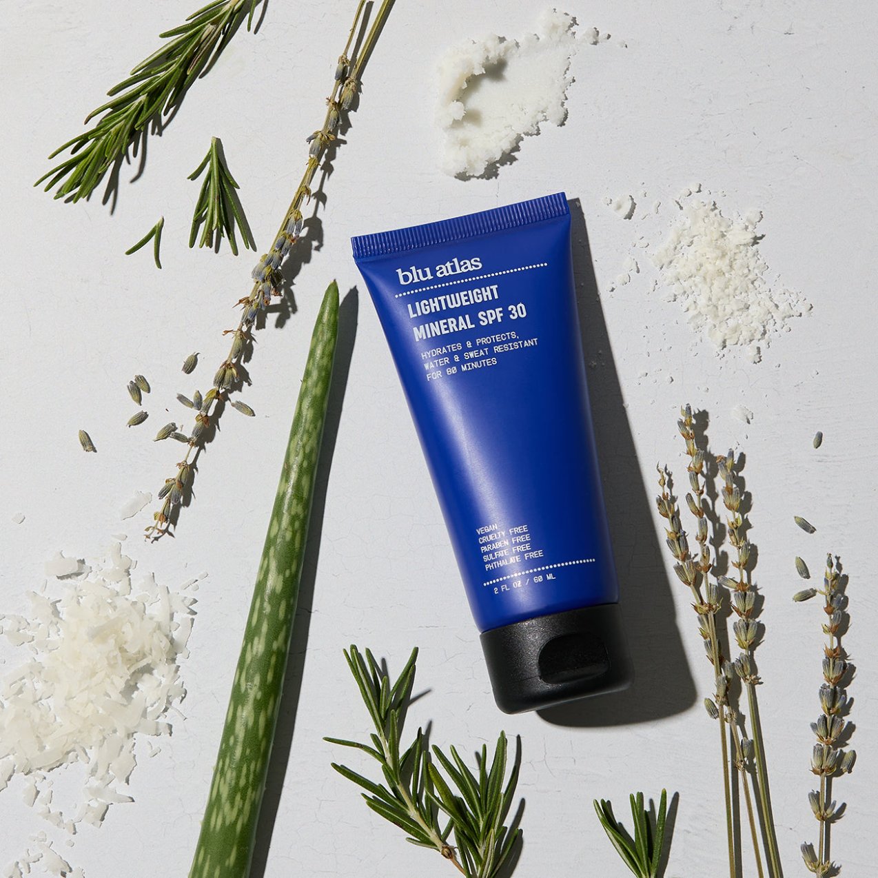 Lightweight mineral SPF 30 sunscreen tube with herbs and white salt-like granules