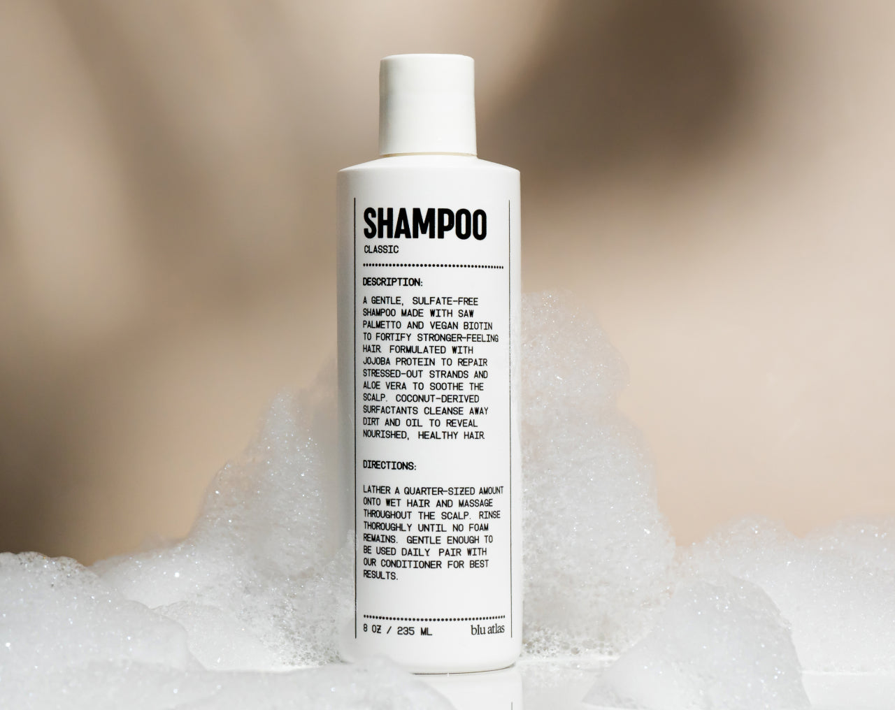Natural shampoo bottle standing in foamy lather