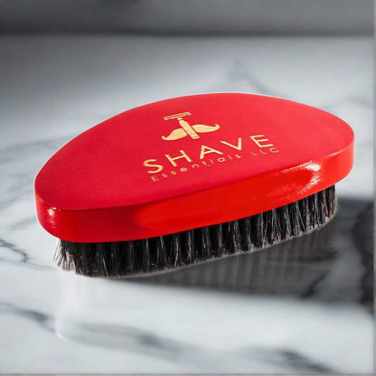 Red boar bristle hair brush with rounded top and dense bristle pad