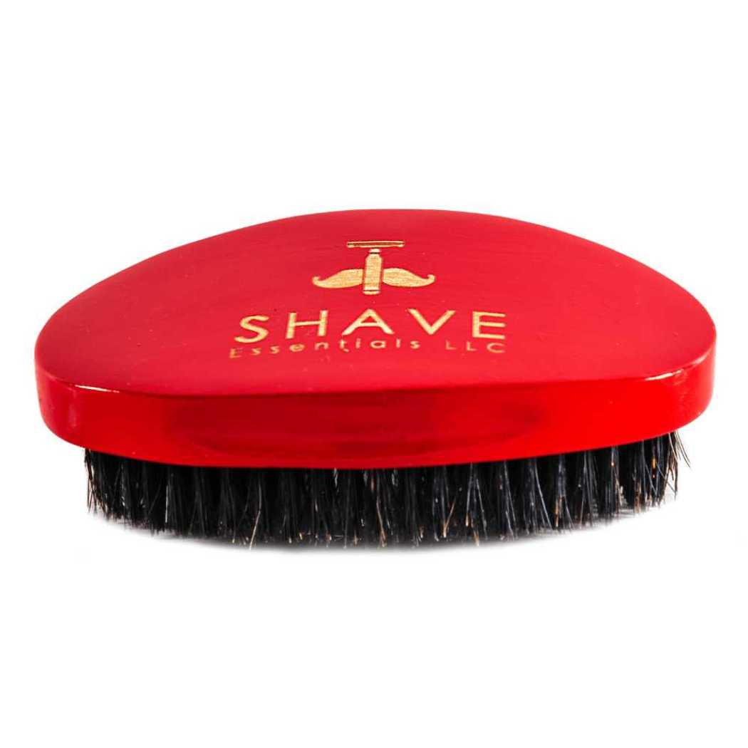 Red boar bristle hair brush with oval top and dense bristle base