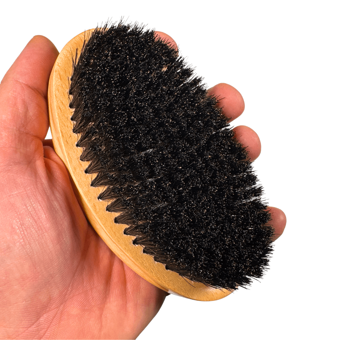 Wood boar bristle hair brush with black bristle side held in hand