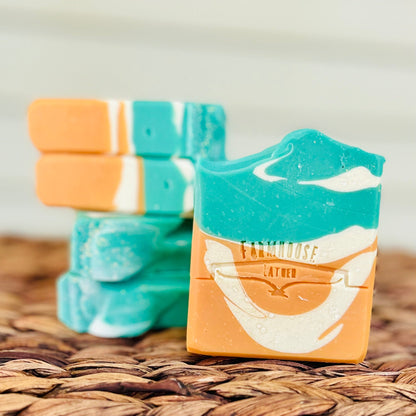 Orange and turquoise layered soap bar with stamped label on front
