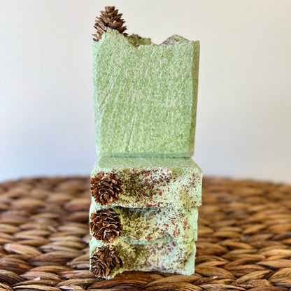 Vertical stack of green sea salt soap bars with pinecone accents