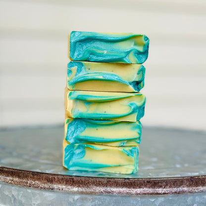 Stack of bar soap with teal and cream layers