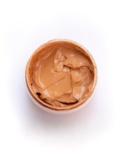 Custom blend foundation in open jar, medium caramel shade cream texture