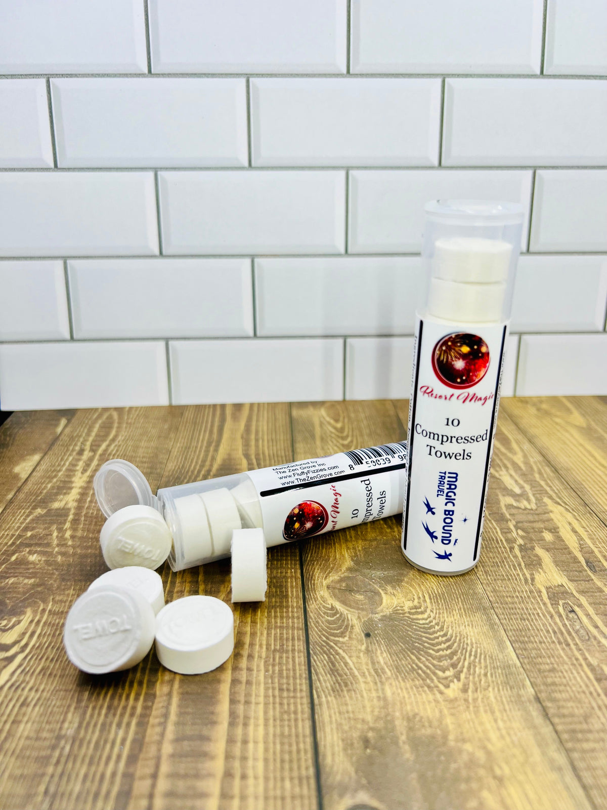 Compressed towel canister with several folded towel discs beside it