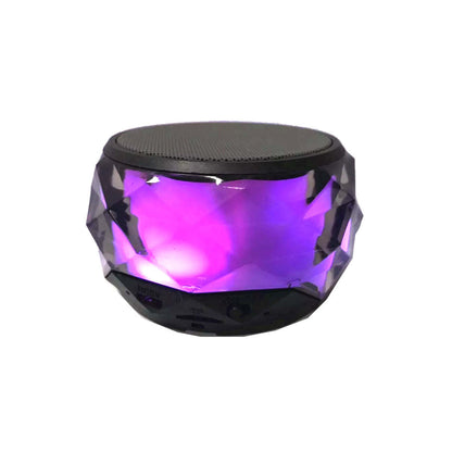 Mini LED Bluetooth speaker with purple glow and faceted sides, black top grille