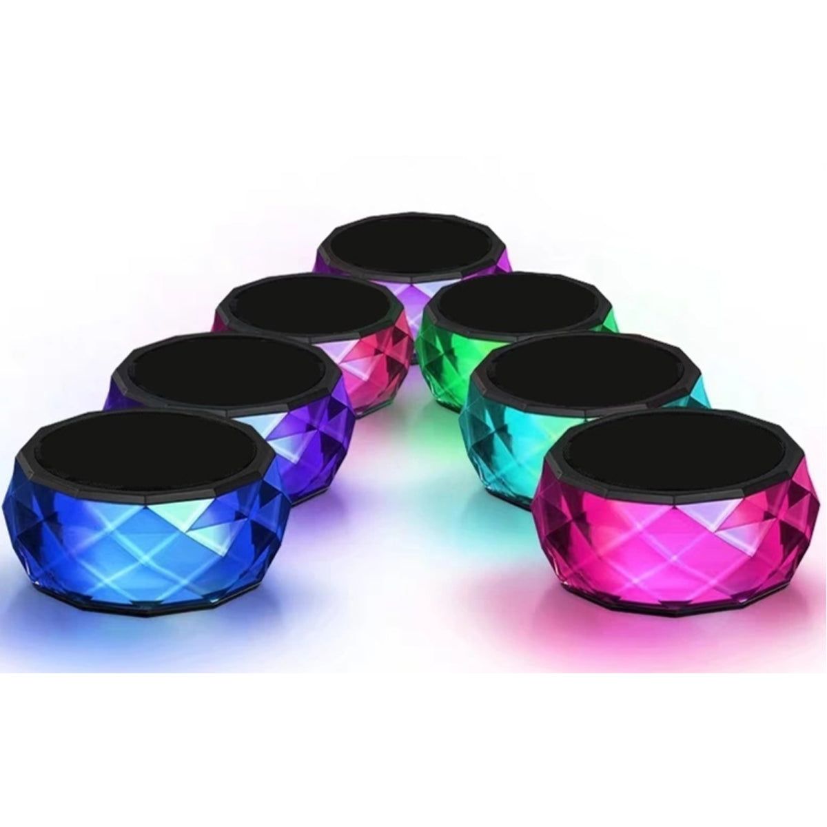 Set of LED mini speakers with faceted blue, green, and pink bodies and black tops.