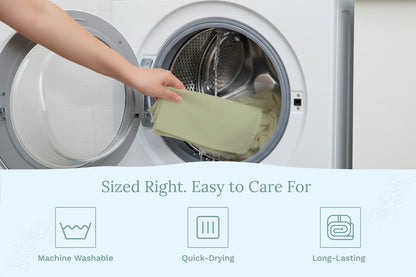 Sage green flour sack kitchen towel being placed into a washing machine