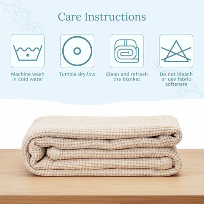 Waffle-weave blanket stack in light beige, neatly folded with textured grid.