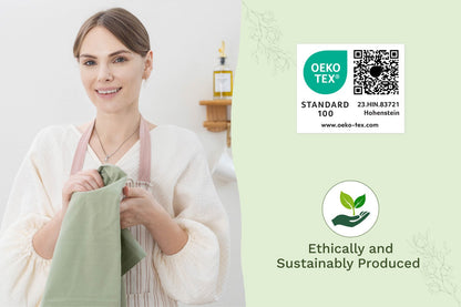Sage green flour sack kitchen towel, folded and held