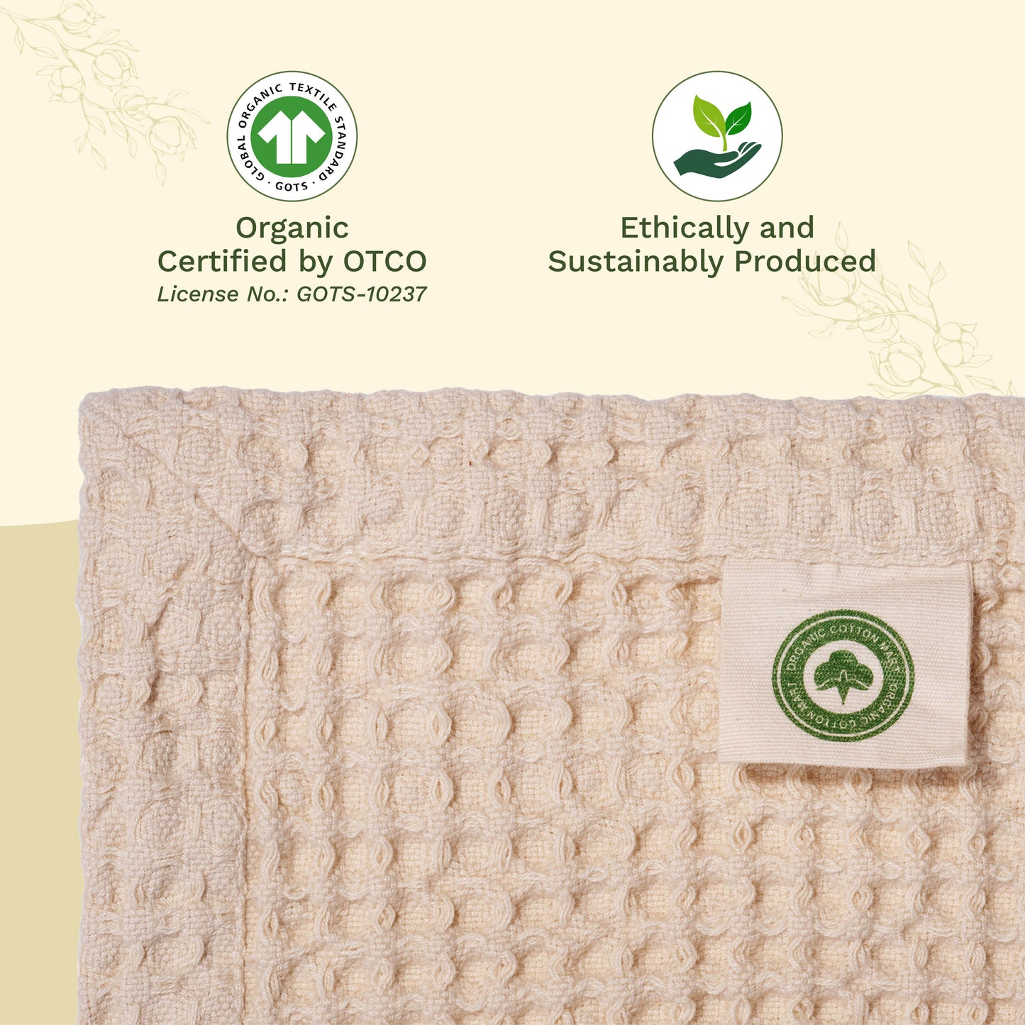 Waffle-weave blanket in light beige, folded edge with fabric label.