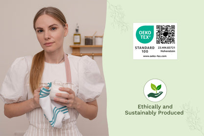 Teal striped kitchen towel held by a person in a white apron