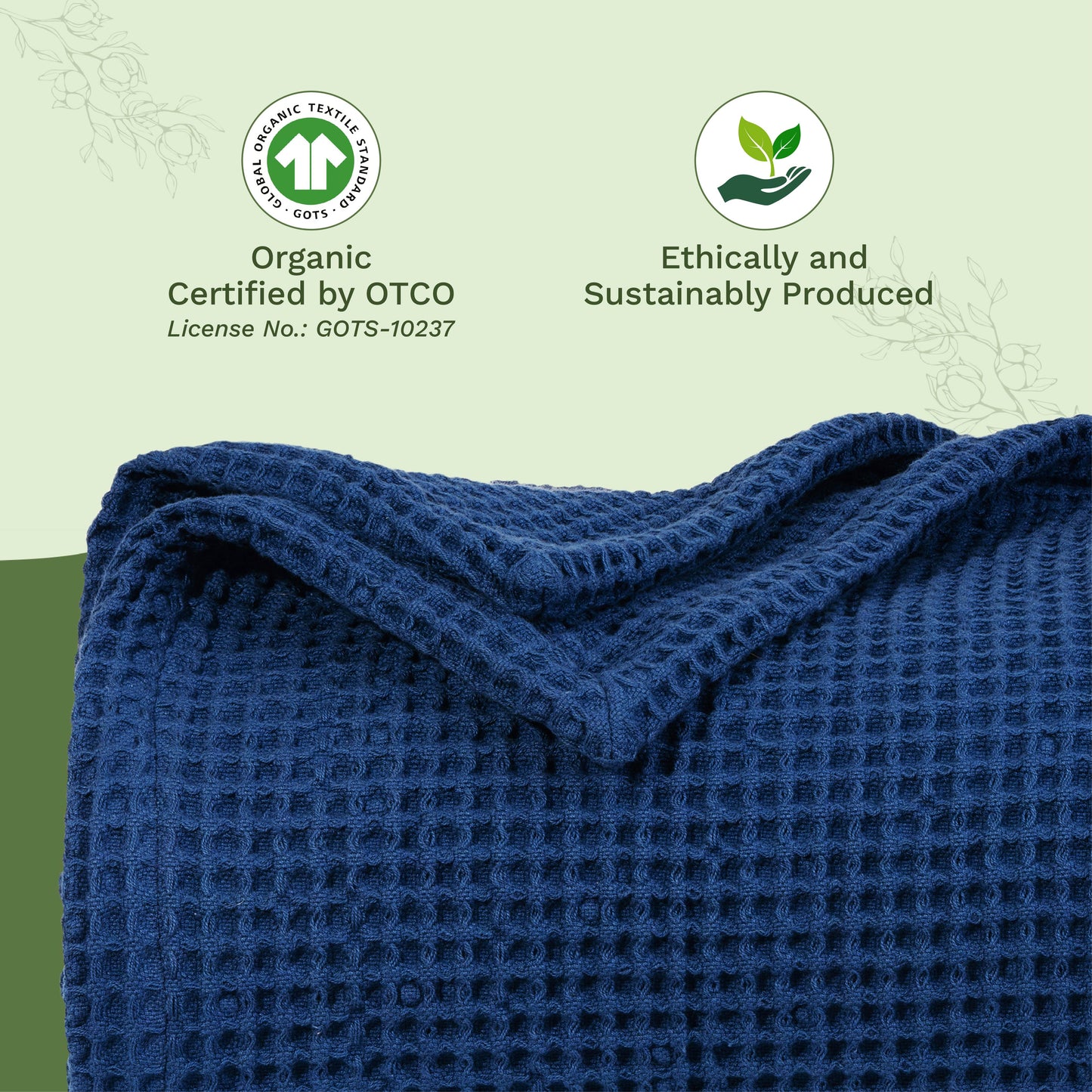 Waffle-weave blanket close-up in dark blue, folded with textured waffle squares.