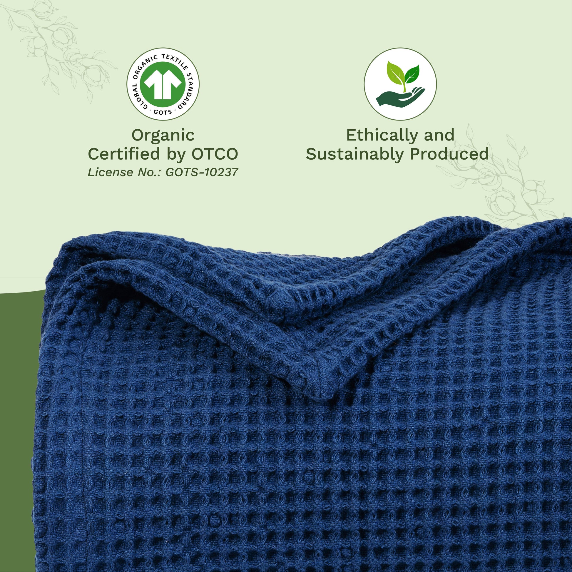 Waffle-weave blanket close-up in dark blue, folded with textured waffle squares.