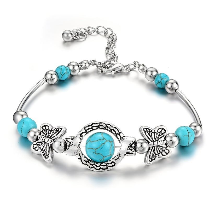 Silver-tone turquoise butterfly charm bracelet with round turquoise centerpiece