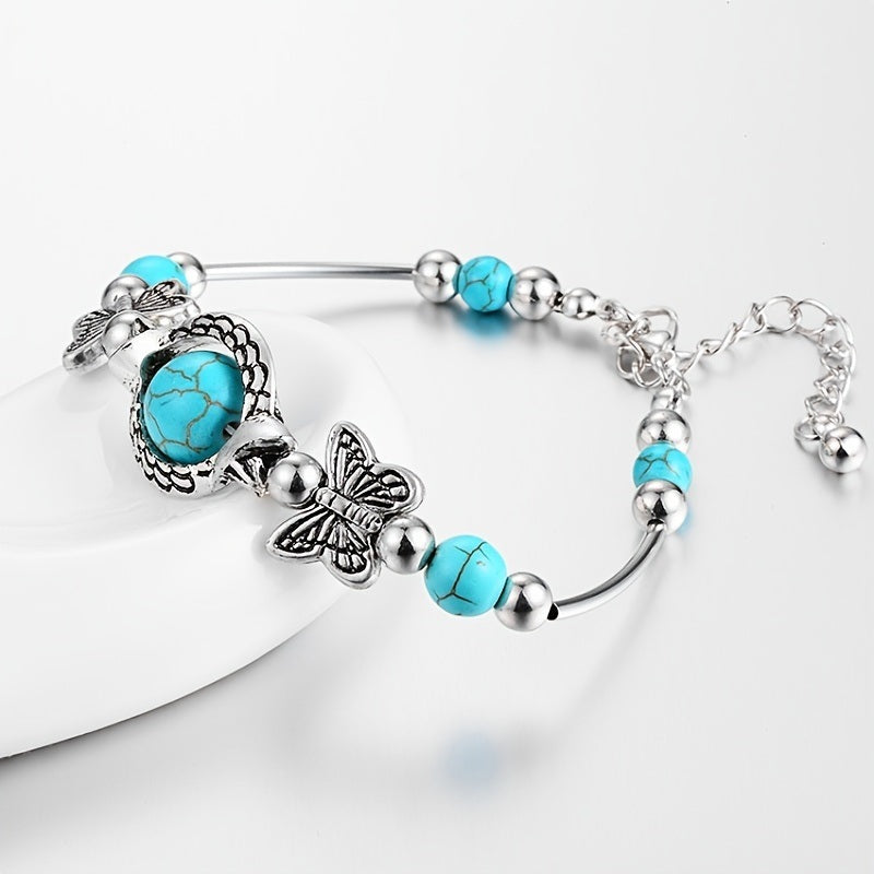 Silver-tone turquoise beaded bracelet with butterfly charms and cabochon centerpiece