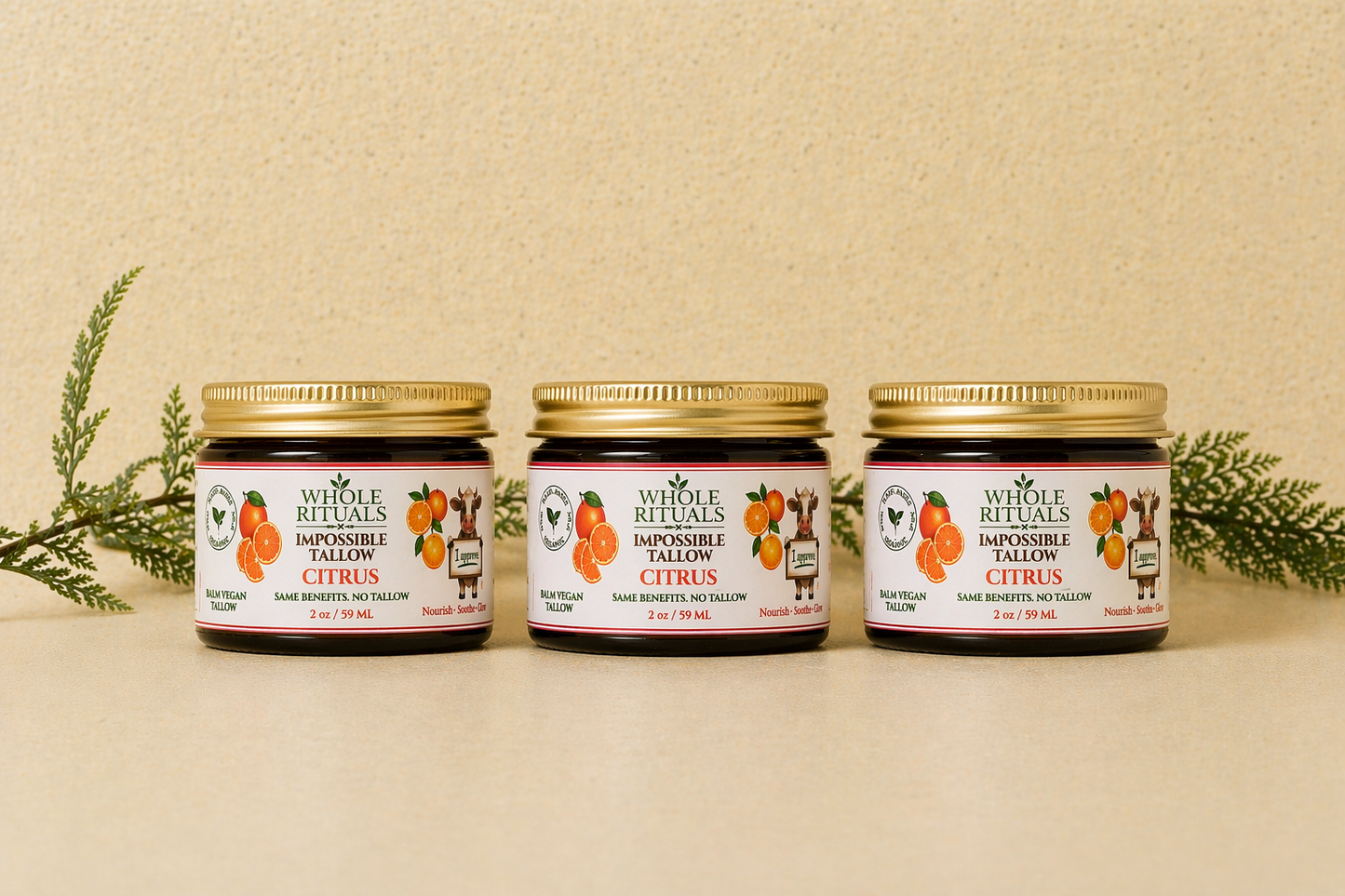 Three citrus balm jars with gold lids and matching orange labels